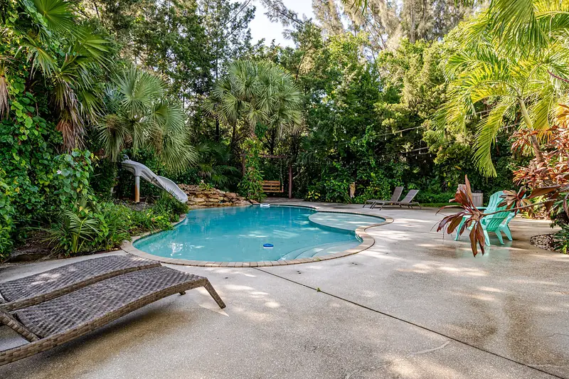 Freeform pool with the slide and rock waterfall