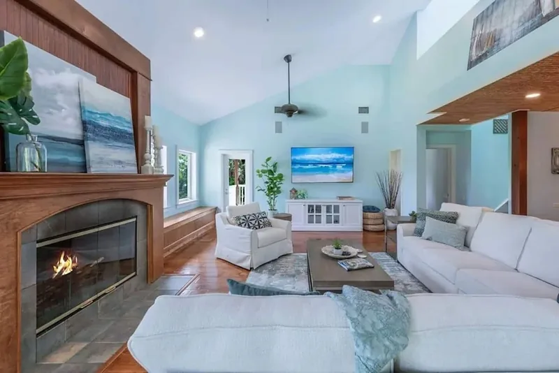Living room with a fireplace and white sofas