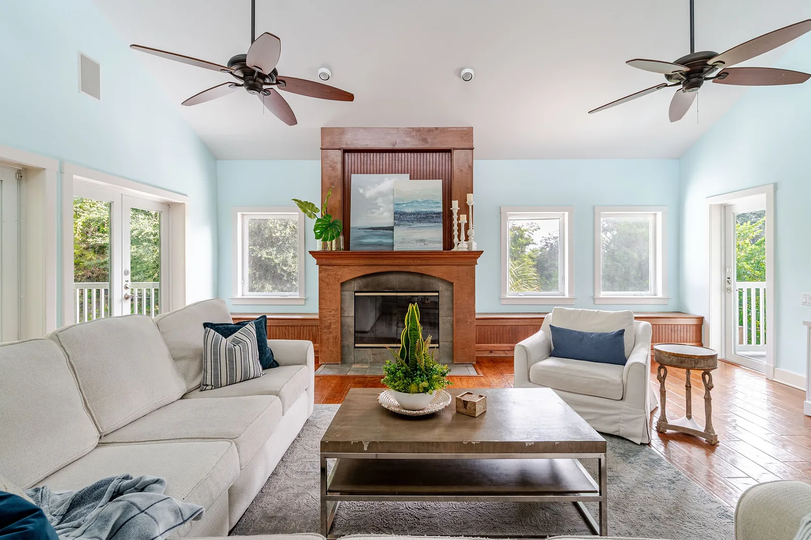 Living room with a fireplace and windows on three sides
