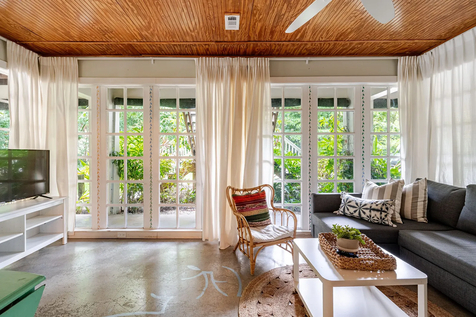 Sunroom with a sectional sofa, wrapped in windows