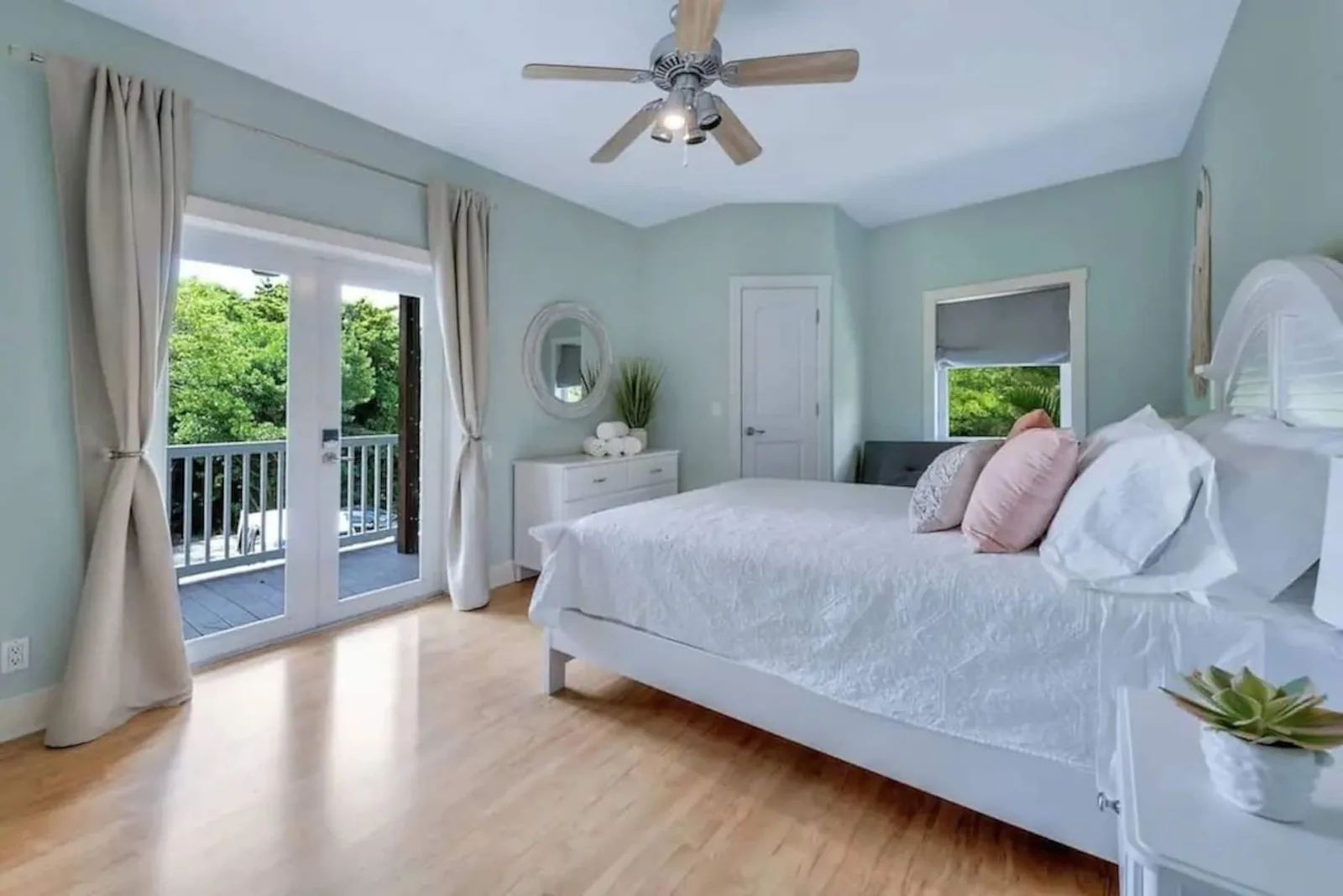 Second bedroom with a queen bed and French doors to the porch