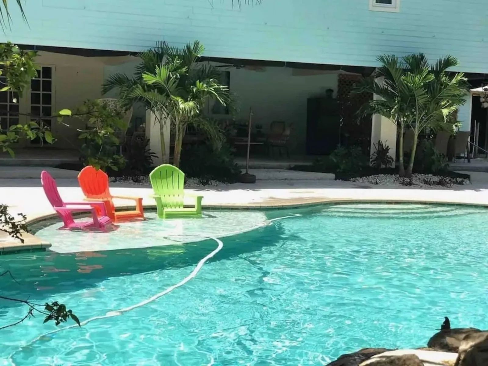 Adirondack chairs on the pool's shallow ledge