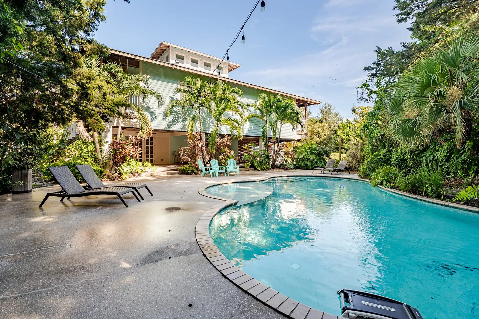 The pool in the garden with the house behind