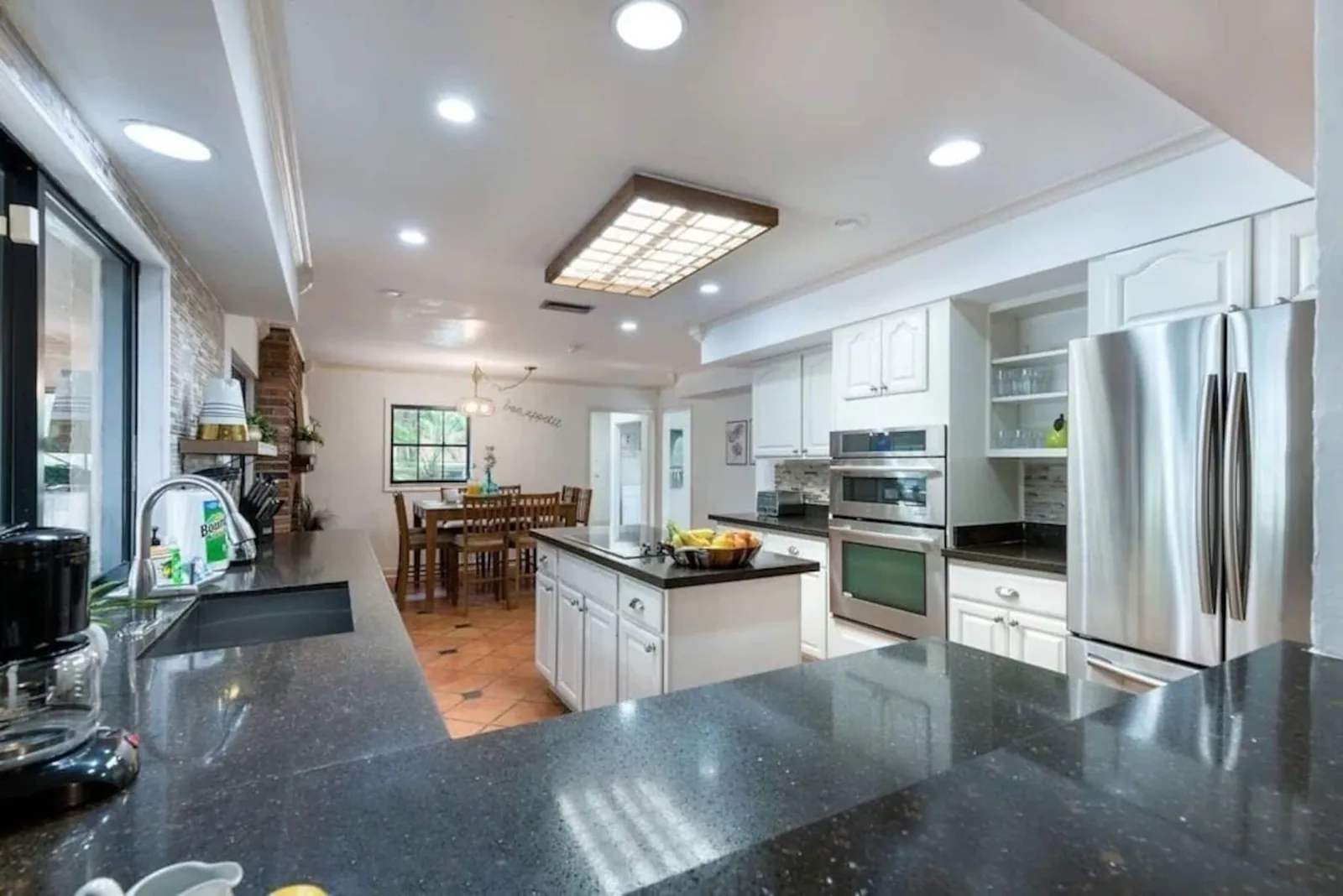Kitchen with black counters and stainless appliances
