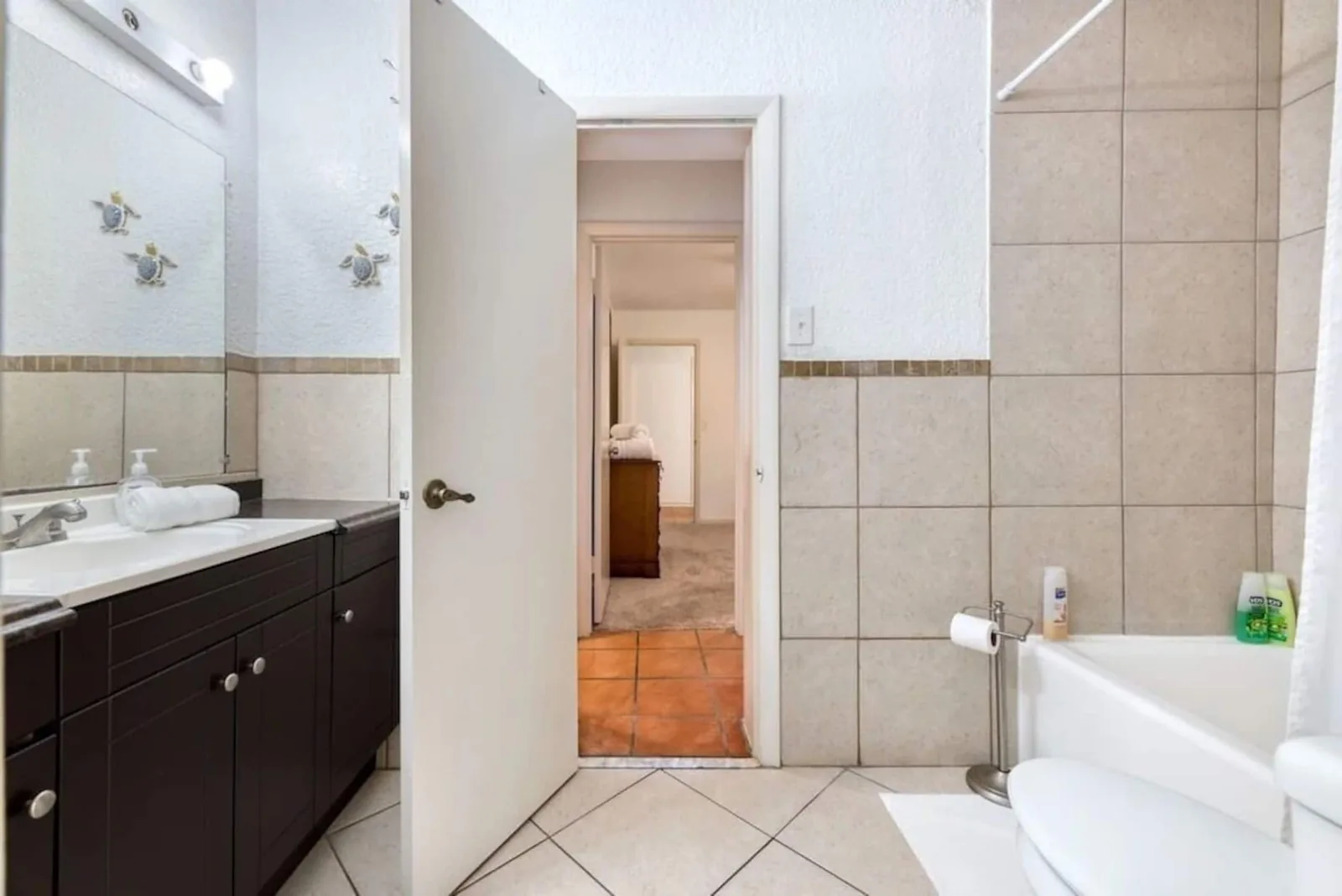 Second bedroom bathroom with a tub and shower