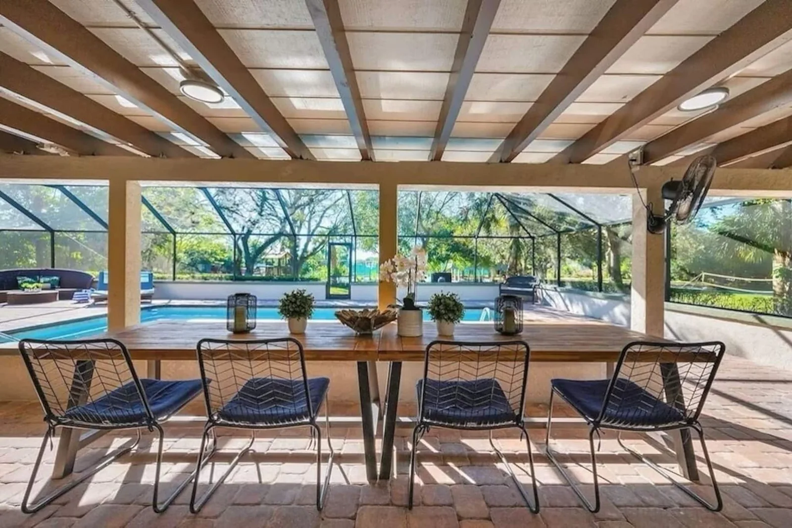Dining table on the lanai, looking out to the pool