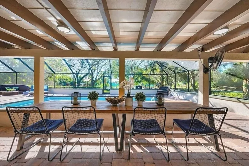 Dining table on the lanai looking out to the pool