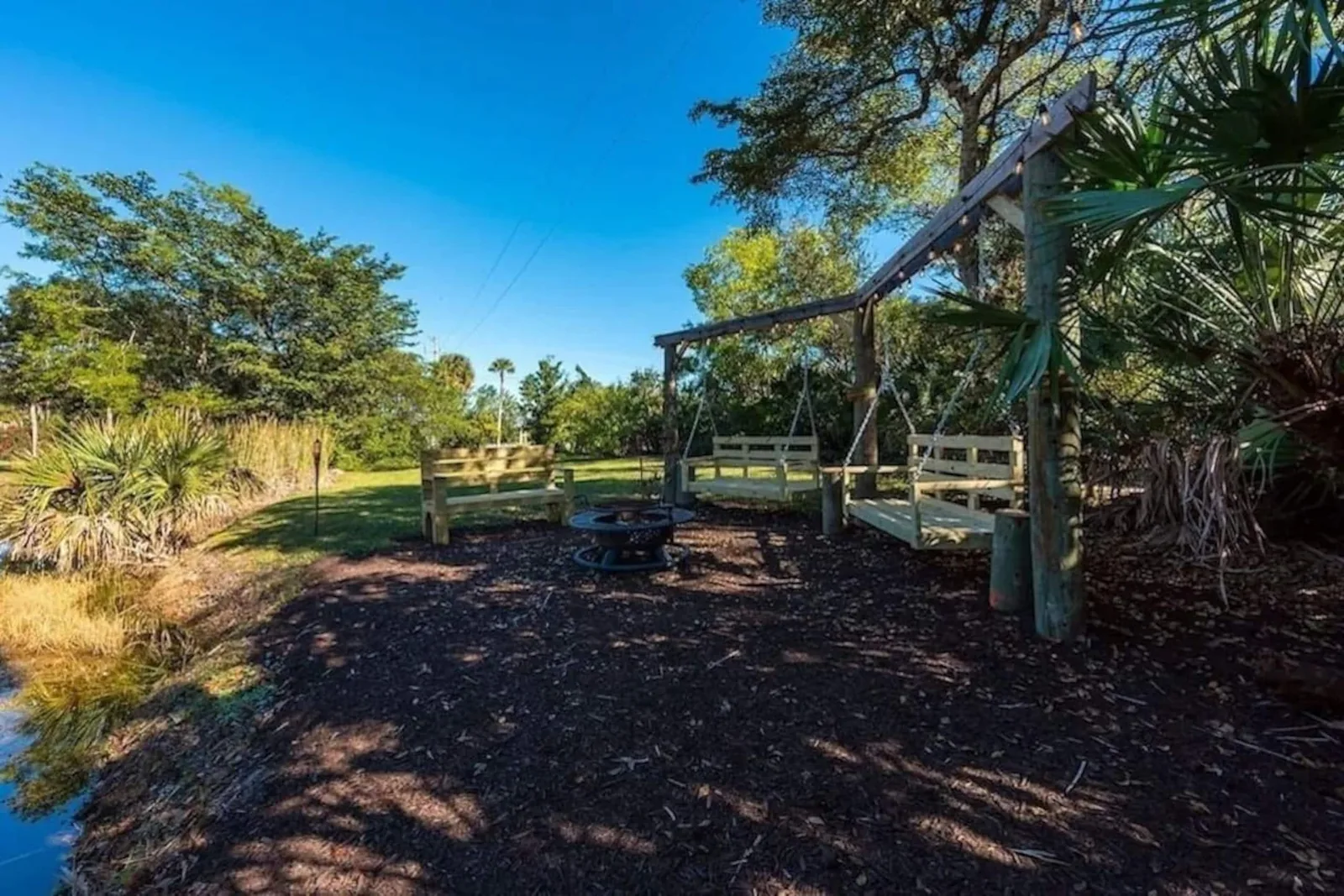 Swing and fire pit in the front yard