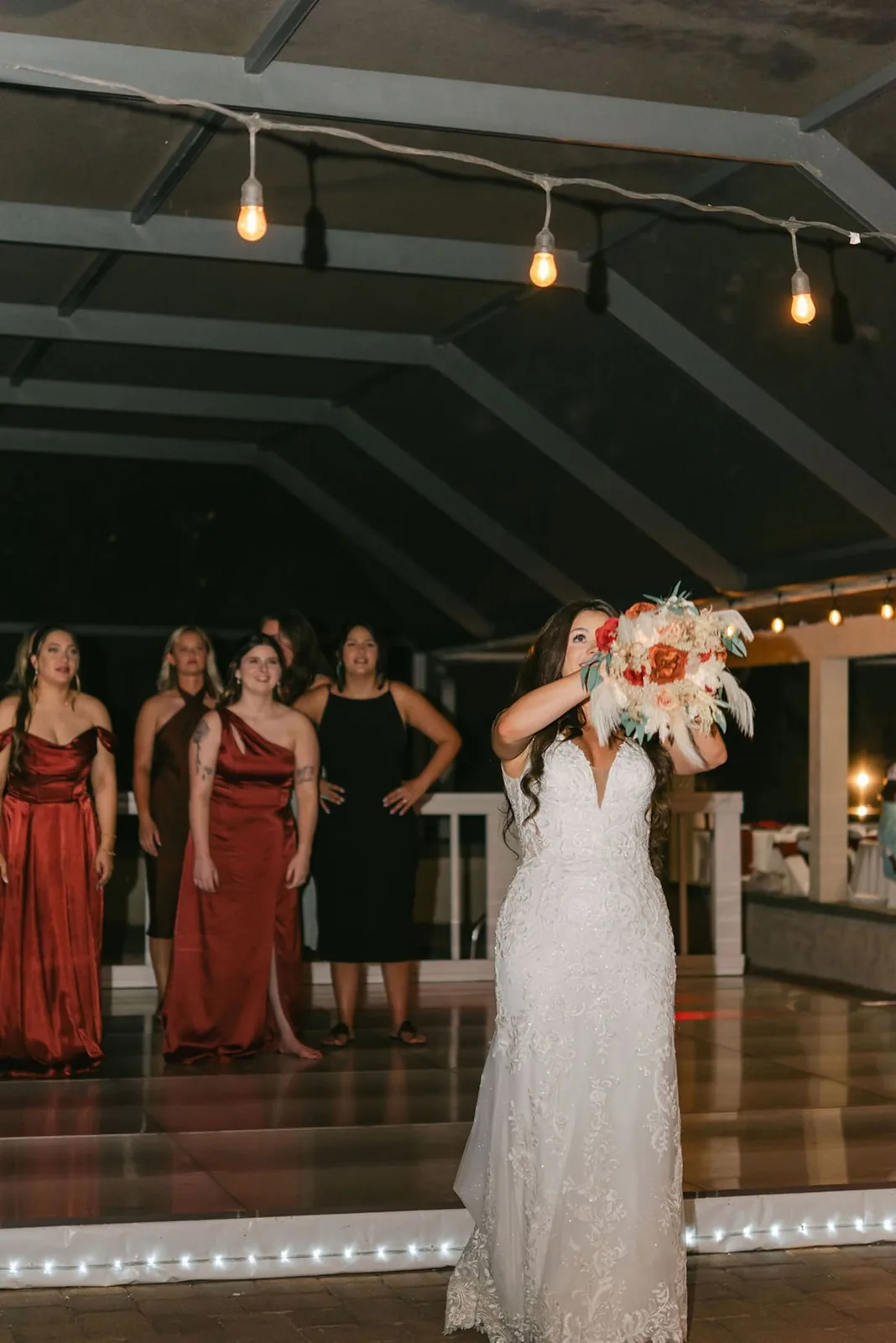 Bride at an evening reception under string lights