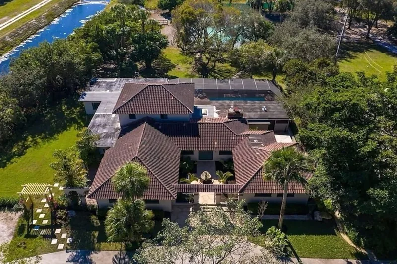 Aerial view of Grand Hacienda among oaks and palms
